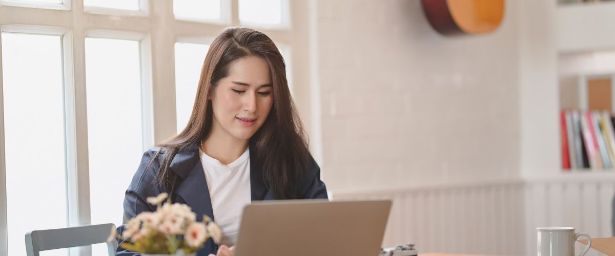 young woman looking at her computer